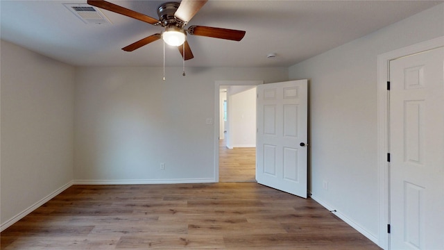 1002 Francis Dr, Pasadena, TX 77506 - unfurnished bedroom featuring wood finished floors, baseboards, and a ceiling fan