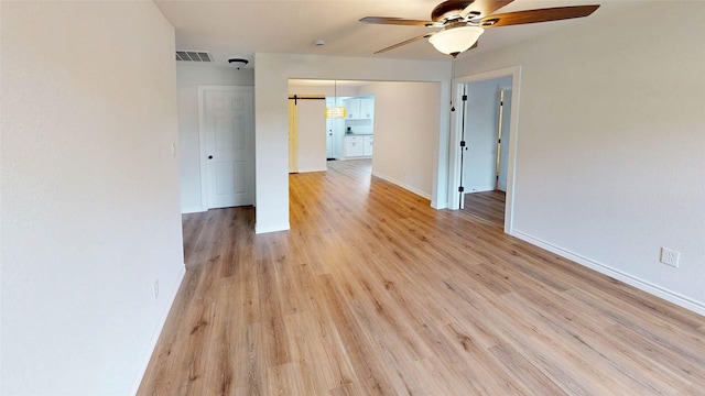 1002 Francis Dr, Pasadena, TX 77506 - unfurnished room with ceiling fan, baseboards, and light wood finished floors