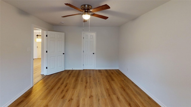 1002 Francis Dr, Pasadena, TX 77506 - unfurnished bedroom featuring light wood finished floors, baseboards, and ceiling fan