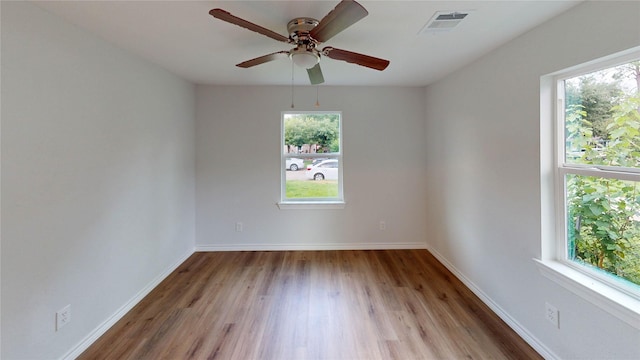 1002 Francis Dr, Pasadena, TX 77506 - unfurnished room featuring healthy amount of natural light, wood finished floors, a ceiling fan, and baseboards