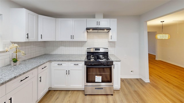 1002 Francis Dr, Pasadena, TX 77506 - kitchen with gas stove, light wood-type flooring, white cabinets, and a chandelier