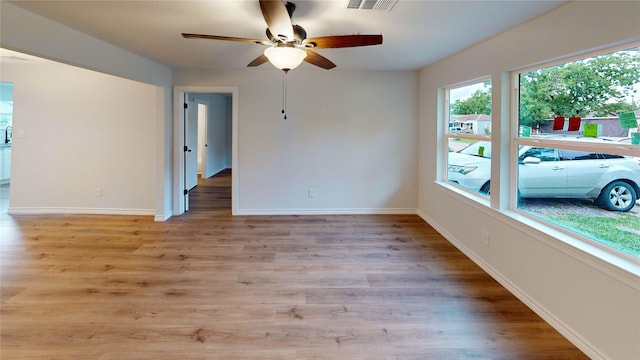 1002 Francis Dr, Pasadena, TX 77506 - unfurnished room with a ceiling fan, baseboards, and light wood-style flooring