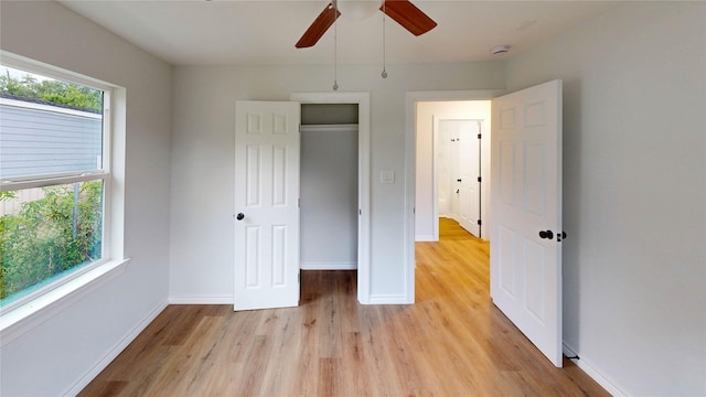1002 Francis Dr, Pasadena, TX 77506 - unfurnished bedroom featuring light wood-style flooring, baseboards, and a ceiling fan