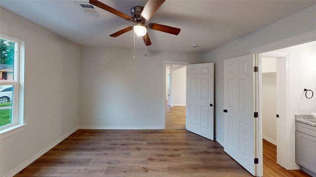 1002 Francis Dr, Pasadena, TX 77506 - unfurnished bedroom featuring light wood-style flooring, baseboards, and ceiling fan