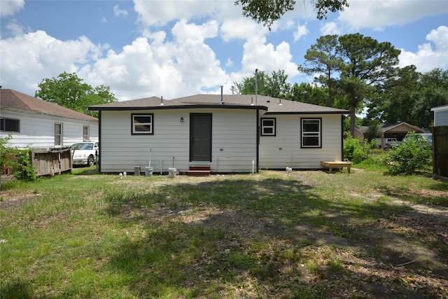 1002 Francis Dr, Pasadena, TX 77506 - rear view of property with entry steps and a yard