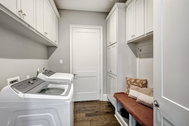 clothes washing area featuring independent washer and dryer, cabinet space, and dark wood-type flooring