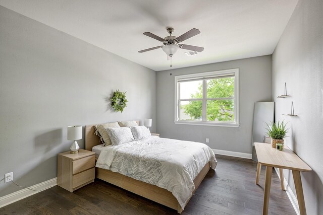 bedroom featuring baseboards, visible vents, ceiling fan, and dark wood-type flooring