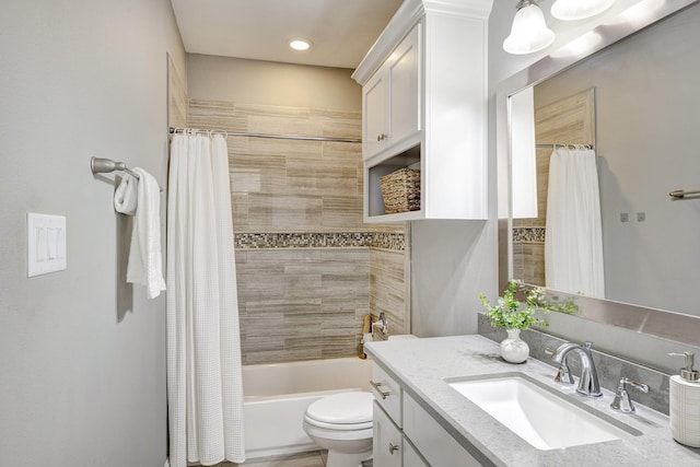 full bath with vanity, shower / bath combo with shower curtain, and toilet