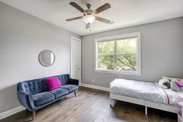 bedroom with baseboards, a ceiling fan, and wood finished floors