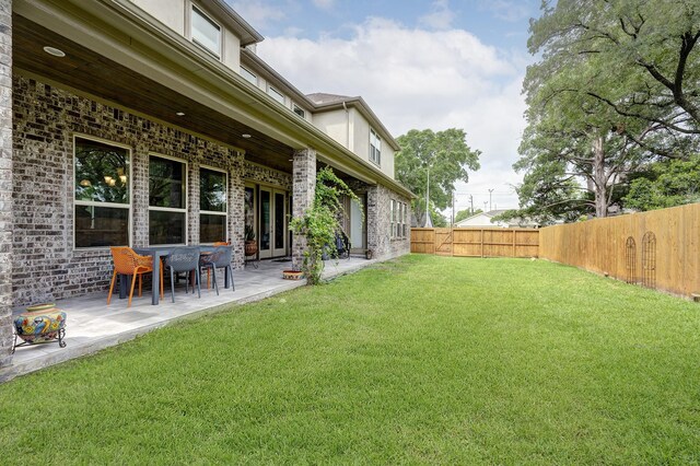 view of yard with a patio and a fenced backyard