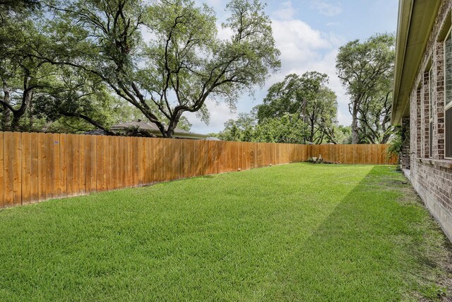 view of yard with a fenced backyard