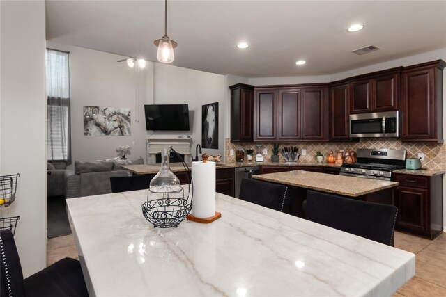 kitchen featuring visible vents, appliances with stainless steel finishes, tasteful backsplash, light tile patterned floors, and open floor plan