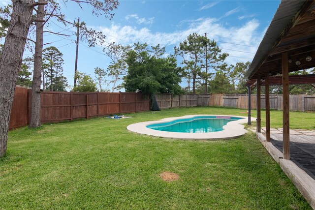 view of pool with a yard, a fenced in pool, and a fenced backyard