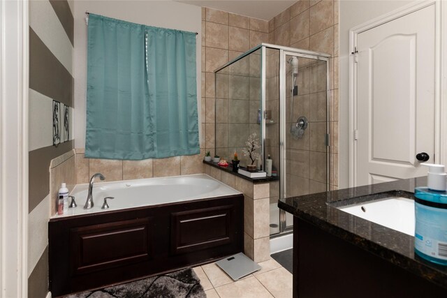 full bathroom featuring tile patterned flooring, a stall shower, and a garden tub