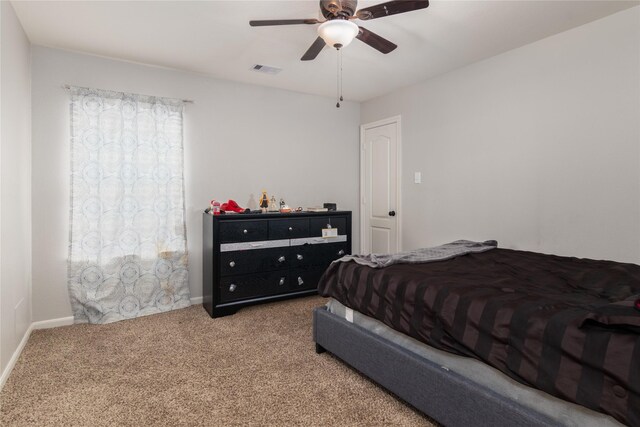 bedroom featuring carpet floors, baseboards, ceiling fan, and visible vents