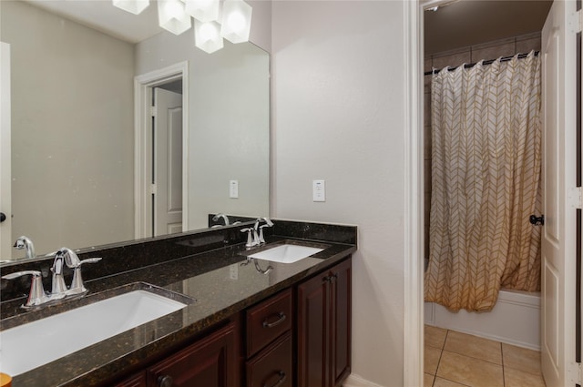 bathroom with double vanity, a sink, tile patterned floors, and shower / bath combo