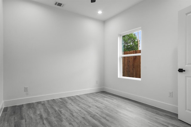 unfurnished room with a ceiling fan, baseboards, visible vents, and wood finished floors