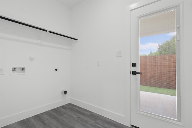 clothes washing area featuring laundry area, dark wood-style flooring, electric dryer hookup, hookup for a gas dryer, and baseboards