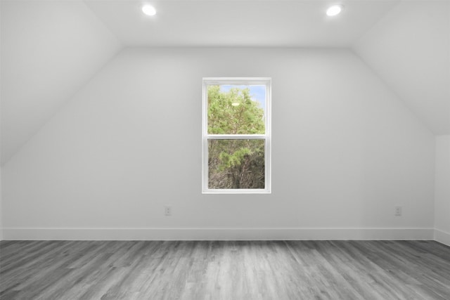 additional living space featuring wood finished floors, recessed lighting, and lofted ceiling