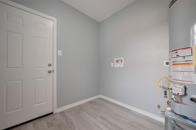 laundry room with laundry area, gas water heater, light wood-style flooring, baseboards, and hookup for an electric dryer