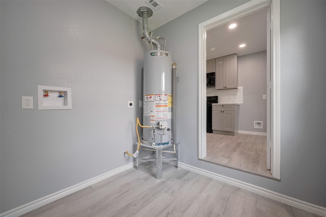 utility room with visible vents and gas water heater