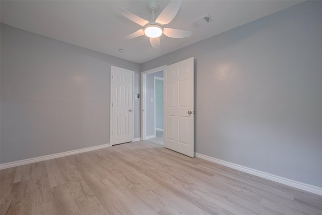 unfurnished bedroom with baseboards, a ceiling fan, light wood-type flooring, and visible vents