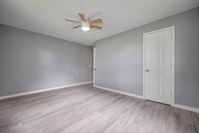 unfurnished room with a ceiling fan, baseboards, and wood finished floors
