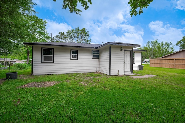 back of house with a lawn