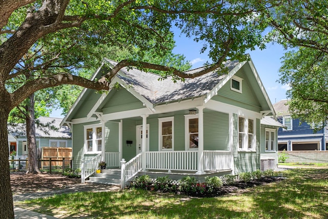401 Omar St, Houston, TX 77009 - view of front facade with a porch, fence, and a shingled roof