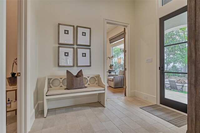 foyer featuring baseboards and light wood finished floors