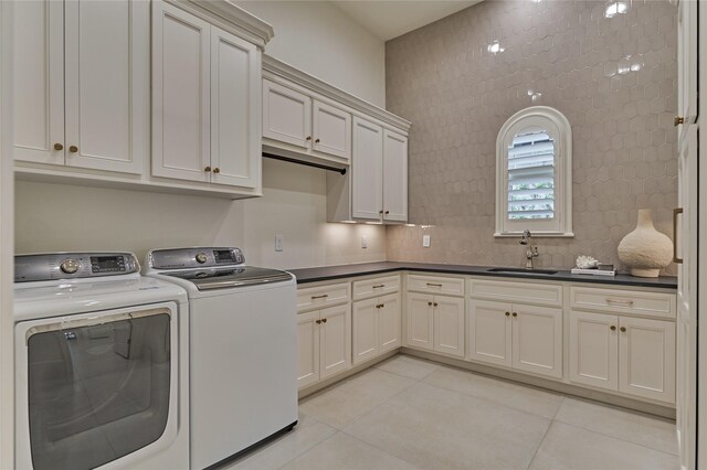 clothes washing area with a sink, separate washer and dryer, light tile patterned flooring, and cabinet space