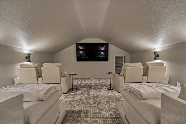carpeted cinema with vaulted ceiling and a textured ceiling