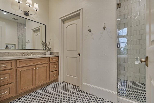 bathroom with visible vents, vanity, baseboards, tile patterned floors, and a stall shower
