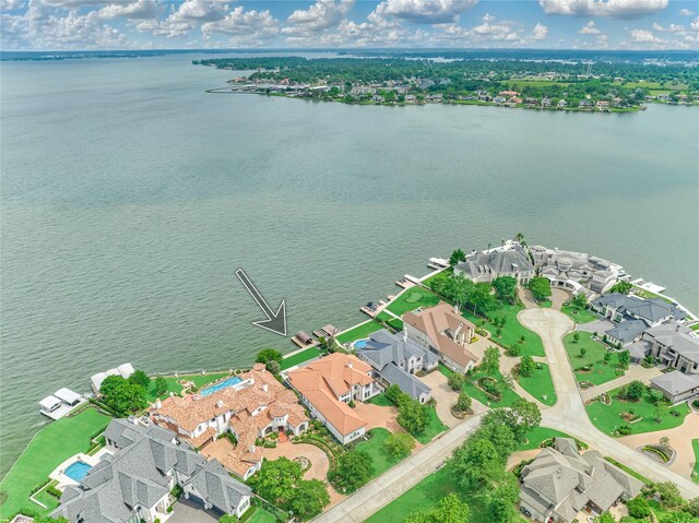 drone / aerial view with a water view and a residential view