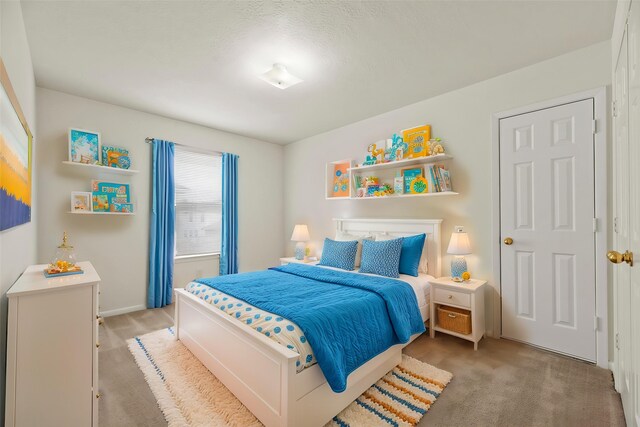 carpeted bedroom featuring baseboards