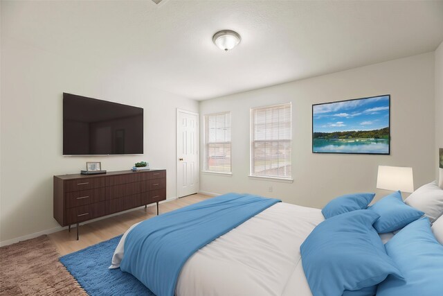 bedroom featuring baseboards and light wood-type flooring