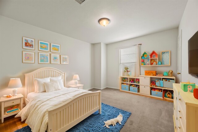 bedroom with carpet floors and baseboards