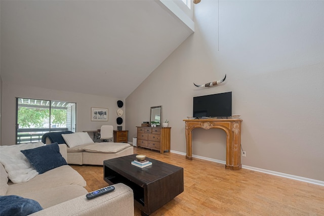 182 April Point Dr N, Conroe, TX 77356 - living area featuring high vaulted ceiling, baseboards, and light wood finished floors