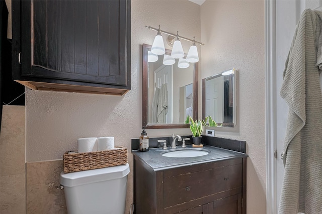 182 April Point Dr N, Conroe, TX 77356 - full bath featuring vanity, a textured wall, and toilet