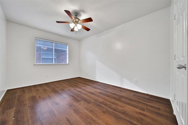 unfurnished room with wood-type flooring, a ceiling fan, and baseboards