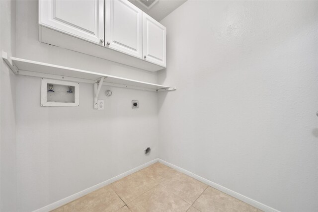 laundry area featuring light tile patterned flooring, baseboards, cabinet space, washer hookup, and hookup for an electric dryer