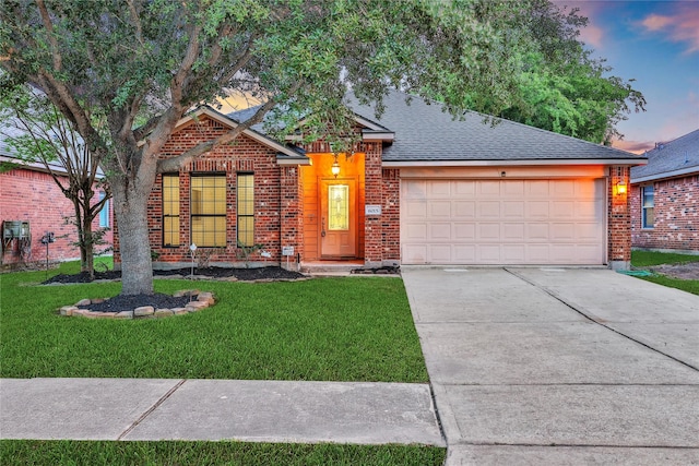 view of front facade with a lawn, brick siding, concrete driveway, and a garage