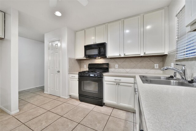 kitchen featuring a sink, decorative backsplash, black appliances, and white cabinets