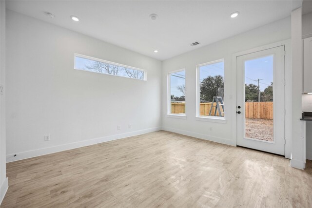 unfurnished room with recessed lighting, baseboards, visible vents, and light wood finished floors
