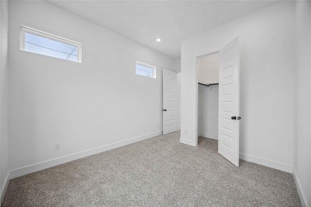 unfurnished bedroom with carpet flooring, recessed lighting, baseboards, and a closet