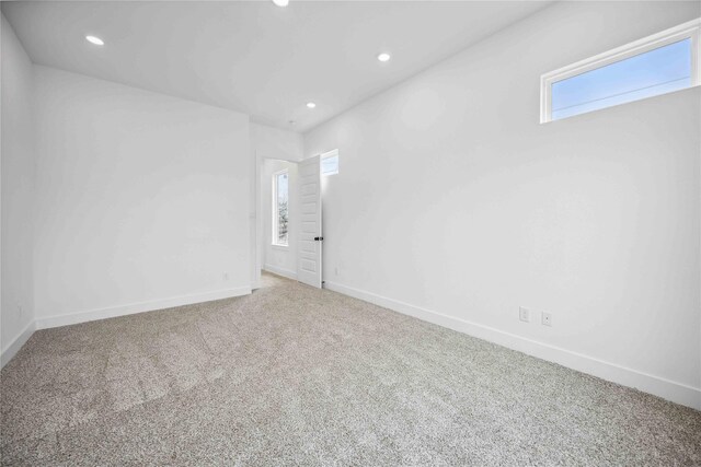 spare room featuring carpet floors, recessed lighting, and baseboards
