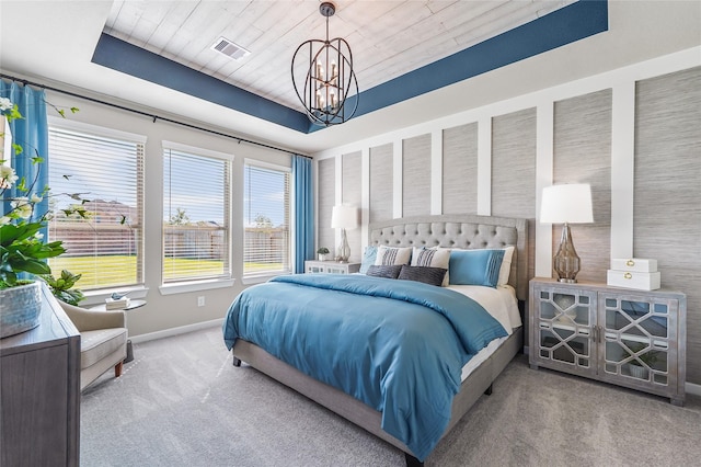 bedroom featuring baseboards, visible vents, carpet, and a notable chandelier