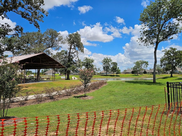 view of property's community featuring a water view, a gazebo, and a yard