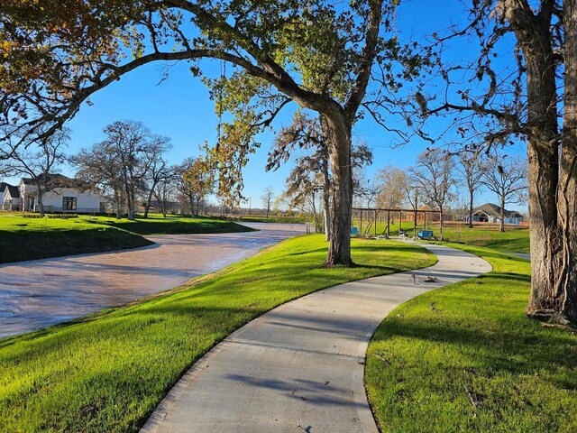 view of property's community with a yard