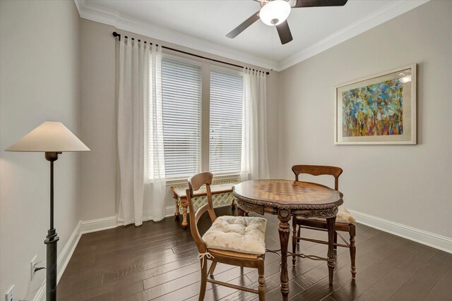 dining space with baseboards, a ceiling fan, dark wood-type flooring, and crown molding